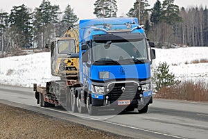 Blue Renault Trucks T Hauls Construction Equipment